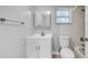 Bright bathroom features a vanity with storage, framed mirror, and a toilet with tub and shower at 2122 Bradford St # 505, Clearwater, FL 33760