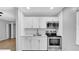 Kitchen with stainless steel appliances, crisp, white cabinetry and tile backsplash at 2122 Bradford St # 505, Clearwater, FL 33760