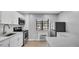 Modern kitchen boasts white cabinets, stainless steel appliances, and updated fixtures at 2122 Bradford St # 505, Clearwater, FL 33760