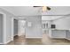 Newly renovated living room features laminate wood flooring and opens to kitchen area at 2122 Bradford St # 505, Clearwater, FL 33760