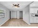 Spacious living room with laminate floors, ceiling fan, and a kitchen view at 2122 Bradford St # 505, Clearwater, FL 33760
