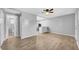 Spacious living room with wood-look floors and an opening to the adjacent kitchen area at 2122 Bradford St # 505, Clearwater, FL 33760