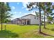 Spacious backyard with a screened-in patio, lush green lawn, and mature trees for added privacy at 21383 Southern Charm Dr, Land O Lakes, FL 34637