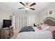 Comfortable bedroom featuring a ceiling fan, ample natural light, and neutral décor at 21383 Southern Charm Dr, Land O Lakes, FL 34637