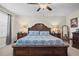 Bedroom featuring a decorative bed frame, matching nightstands, and bright natural lighting at 21383 Southern Charm Dr, Land O Lakes, FL 34637