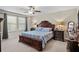 Primary bedroom featuring a decorative wood bed frame, matching nightstands, and relaxing ambiance at 21383 Southern Charm Dr, Land O Lakes, FL 34637