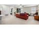 Spacious bonus room with a comfortable couch and view to the bedroom through the open doorway at 21383 Southern Charm Dr, Land O Lakes, FL 34637