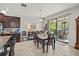 Dining area open to kitchen with table, chairs, and sliding door access to lanai at 21383 Southern Charm Dr, Land O Lakes, FL 34637