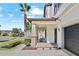Charming covered front porch with comfortable seating and decorative stone accents on the pillars at 21383 Southern Charm Dr, Land O Lakes, FL 34637