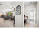 Hallway featuring an arched mirror, convenient bar area, and a view to the powder room at 21383 Southern Charm Dr, Land O Lakes, FL 34637