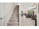 Hallway with stairs leading to the upper level, offering a glimpse into the living space at 21383 Southern Charm Dr, Land O Lakes, FL 34637