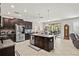 Spacious kitchen featuring dark cabinets, granite countertops, and stainless steel appliances at 21383 Southern Charm Dr, Land O Lakes, FL 34637
