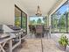Covered lanai with dining table, chairs, and grill at 21383 Southern Charm Dr, Land O Lakes, FL 34637
