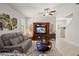 Inviting living room with ceiling fan, entertainment center, and comfortable gray reclining couch at 21383 Southern Charm Dr, Land O Lakes, FL 34637