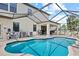 Screened-in pool area with a covered patio and well-maintained backyard at 21383 Southern Charm Dr, Land O Lakes, FL 34637