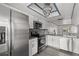Kitchen showcasing stainless steel appliances, white cabinetry, and a modern chandelier at 2275 62Nd N Ave # 5202, St Petersburg, FL 33702