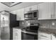 Well-equipped kitchen features sleek stainless steel appliances and stylish granite countertops at 2275 62Nd N Ave # 5202, St Petersburg, FL 33702