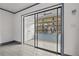 Bright living room featuring a sliding glass door to a balcony and gray wood-look floors at 2275 62Nd N Ave # 5202, St Petersburg, FL 33702