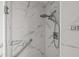 Updated shower featuring marble tile, glass shelf, and rainfall shower head at 2275 62Nd N Ave # 5202, St Petersburg, FL 33702