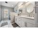 Bright bathroom featuring double vanity, white cabinets, quartz countertops, and walk-in shower at 25324 Lexington Oaks Blvd, Wesley Chapel, FL 33544