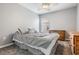 Neutral bedroom with large window, plush carpet, and wood furniture at 25324 Lexington Oaks Blvd, Wesley Chapel, FL 33544