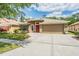 Attractive single-Gathering home with a neutral color palette, well-maintained landscaping, and an attached two-car garage at 25324 Lexington Oaks Blvd, Wesley Chapel, FL 33544