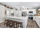 Bright eat-in kitchen with stainless steel appliances, white cabinets, quartz countertops, and barstool seating at the island at 25324 Lexington Oaks Blvd, Wesley Chapel, FL 33544