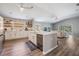 Bright eat-in kitchen with stainless steel appliances, white cabinets, quartz countertops, and open floorplan at 25324 Lexington Oaks Blvd, Wesley Chapel, FL 33544