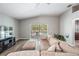 Cozy living room with sliding glass doors to the pool area and sleek, modern flooring at 25324 Lexington Oaks Blvd, Wesley Chapel, FL 33544