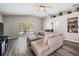 Open living room with modern flooring, comfortable couch, and a view of the pool through sliding doors at 25324 Lexington Oaks Blvd, Wesley Chapel, FL 33544