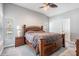 Main bedroom features a vaulted ceiling, neutral color palette, wood furniture, plush carpet, and a large window at 25324 Lexington Oaks Blvd, Wesley Chapel, FL 33544