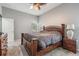 Main bedroom features a neutral color palette, wood furniture, plush carpet, and a large window at 25324 Lexington Oaks Blvd, Wesley Chapel, FL 33544