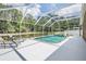 Screened pool area with lounge chairs and views of the pond and garden at 25324 Lexington Oaks Blvd, Wesley Chapel, FL 33544