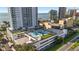 Aerial view showcasing the building's rooftop basketball court and proximity to the water at 2910 W Barcelona St # 1902, Tampa, FL 33629