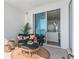 Balcony seating area with an ocean view leads into a modern, open-concept living space at 2910 W Barcelona St # 1902, Tampa, FL 33629