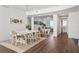 Bright dining room features wood floors, seating for six, and views of the office and bathroom at 2910 W Barcelona St # 1902, Tampa, FL 33629