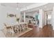 Bright dining room features wood floors, seating for six, and views of the office and bathroom at 2910 W Barcelona St # 1902, Tampa, FL 33629