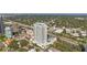 Aerial shot of a modern high-rise featuring a rooftop pool and beautiful surrounding landscape at 2910 W Barcelona St # 1902, Tampa, FL 33629