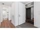 Bright foyer with wood floors and a view into a half bath with pedestal sink and an elevator at 2910 W Barcelona St # 1902, Tampa, FL 33629