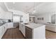 Bright, white kitchen featuring a quartz island, stainless appliances, and modern pendant lighting at 2910 W Barcelona St # 1902, Tampa, FL 33629