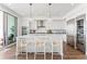 Bright, white kitchen featuring a quartz island, stainless appliances, and modern pendant lighting at 2910 W Barcelona St # 1902, Tampa, FL 33629