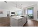 Bright, white kitchen featuring a quartz island, stainless appliances, and access to the balcony at 2910 W Barcelona St # 1902, Tampa, FL 33629
