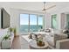 Bright living room with water views and a neutral sectional sofa at 2910 W Barcelona St # 1902, Tampa, FL 33629