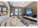 Stylish lounge area with a large sectional sofa, unique lighting, decor, and a large television at 2910 W Barcelona St # 1902, Tampa, FL 33629