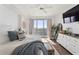 Brightly lit main bedroom has a comfy bed, an exterior view, and a dresser with drawers at 2910 W Barcelona St # 1902, Tampa, FL 33629