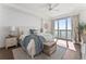 Bright bedroom with a plush bed, an exterior view, and a dresser with drawers at 2910 W Barcelona St # 1902, Tampa, FL 33629