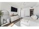 Stylish bedroom with a mounted TV, a large mirror, and a view of the closet at 2910 W Barcelona St # 1902, Tampa, FL 33629