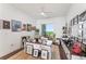 Well-lit office boasts a large window and decorative walls and shelves with wood flooring at 2910 W Barcelona St # 1902, Tampa, FL 33629