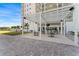 View of an outdoor patio space featuring an awning, seating, and manicured landscape near the building at 2910 W Barcelona St # 1902, Tampa, FL 33629