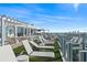 Expansive rooftop deck with a pool, multiple lounge chairs, and city views at 2910 W Barcelona St # 1902, Tampa, FL 33629